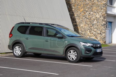 Photo for Labge, France - Feb. 18, 2024 - A brand-new, "khaki lichen" green Dacia Jogger, an MPV, 7-seater estate car produced in Romania by French car manufacturer Renault, in an outdoor parking lot - Royalty Free Image