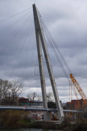 Photo for Toulouse, France - Feb. 23, 2024 - Construction site of Passerelle Rapas, a suspension footbridge connecting Ramier Island to the Left Bank of the Garonne River: view of the steel cable-stayed deck - Royalty Free Image