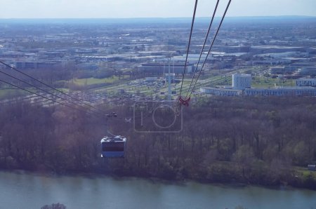 Photo for Toulouse, France - March 15, 2024 - Crossing of the Garonne River by Tlo gondola lift, on the way to Cancer Bio Sant on Oncopole Campus, at the point where the ropeway has the longest span - Royalty Free Image