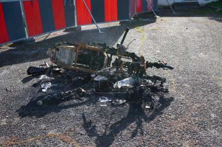 Photo for Toulouse, France - March 15, 2024 - Remnants of a carbonized motor moped by 3R3, a building squatted by far-left "antifa" militias and illegal immigrants, at Toulouse III-Paul Sabatier University - Royalty Free Image