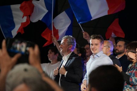 Photo for Palavas-les-Flots, France - April 6, 2024 - Senator Stephane Ravier and President of Generation Z Stanislas Rigault among waving French flags, at an electoral meeting for the European elections - Royalty Free Image