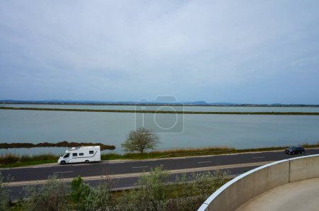 Photo for Palavas-les-Flots, France - April 6, 2024 - View on Mjean and Grec Lagoons in the direction of Montpellier, on the Mediterranean Coast; splitting both lakes is the Rhone River-to-Ste Canal - Royalty Free Image