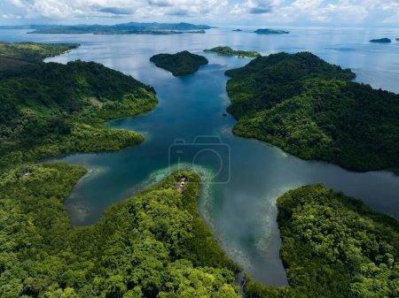Photo for Extensive coral reefs fringe rainforest-covered islands in the Solomon Islands. This beautiful country is home to spectacular marine biodiversity and many historic WWII sites. - Royalty Free Image