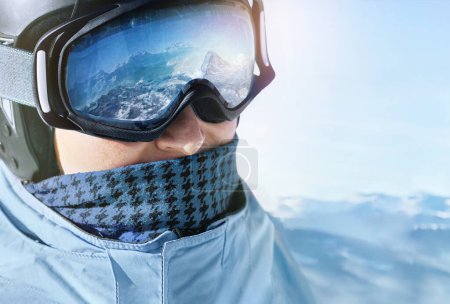 Photo for Close up of the ski goggles of a man with the reflection of snowed mountains. - Royalty Free Image
