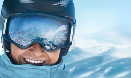 Photo for Close up of the ski goggles of a man with the reflection of snowed mountains.  A mountain range reflected in the ski mask.  Man  on the background blue sky. Wearing ski glasses. Winter Sports. - Royalty Free Image