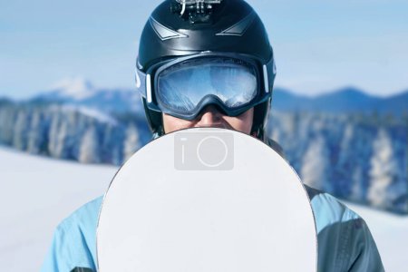 Photo for Close up Portrait of snowboarder in Carpathian Mountains, Bukovel Snowboarder. A mountain range reflected in the ski mask. wearing ski glasses - Royalty Free Image