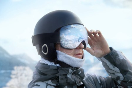 Photo for Close up of the ski goggles of a man with the reflection of snowed mountains. A mountain range reflected in the ski mask. Portrait of man at the ski resort on the background of mountains - Royalty Free Image