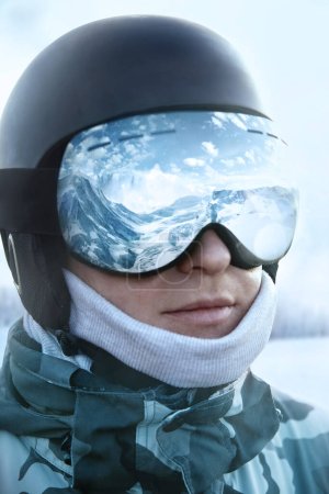 Photo for Ski goggles  with the reflection of snowed mountains. Man on the background blue sky. Winter Sports. - Royalty Free Image