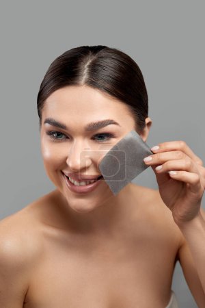 Photo for Beautiful woman using facial oil blotting paper.  Beauty concept. Cosmetology, cosmetics. Facial treatment - Royalty Free Image