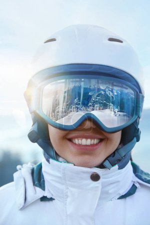 Photo for Close Up Of The Ski Goggles Of A Woman With The Reflection Of Snowed Mountains. A Mountain Range Reflected In The Ski Mask. Winter Sports - Royalty Free Image