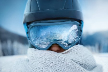 Photo for Woman At The Ski Resort On The Background Of Mountains And Blue Sky.A Mountain Range Reflected In The Ski Mask. Winter Sports. - Royalty Free Image