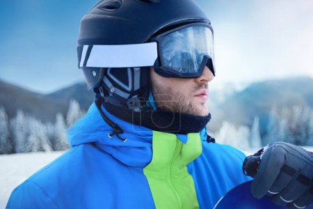Photo for Close up of the ski goggles of a man with the reflection of snowed mountains. A mountain range reflected in the ski mask. Portrait of man at the ski resort on the background of mountains and sky - Royalty Free Image