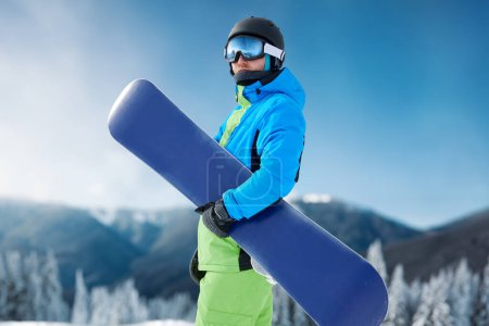 Photo for Snowboarder and snowboard, portrait on a background of mountains - Royalty Free Image
