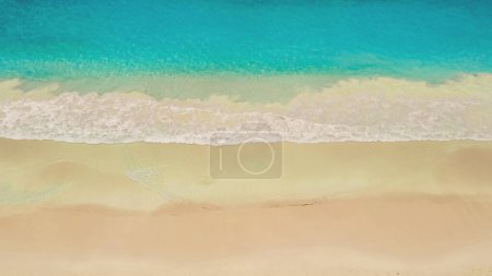Photo for Aerial view of turquoise ocean wave reaching the coastline. Beautiful sand beach from top view. Summer holiday vacation concept. Aerial drone shot of turquoise sea water at the beach, panoramic view. - Royalty Free Image