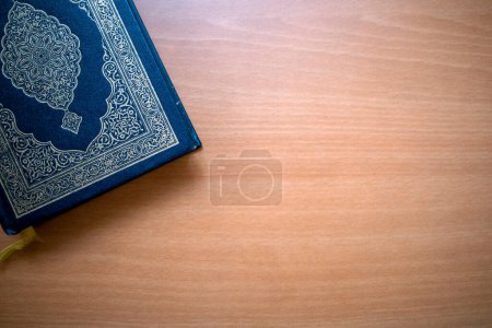 The Qur'an, the holy book of Muslims on a wooden table. Copy space.