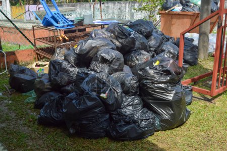 Photo for Klang, Malaysia: December 17, 2022- Pile of black plastic garbage bags at the dump site - Royalty Free Image