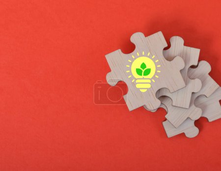 Photo for Jigsaw puzzle with green energy symbol. Energy conservation concept. - Royalty Free Image