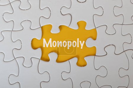 Photo for Missing jigsaw puzzle with text MONOPOLY isolated on a yellow background. - Royalty Free Image