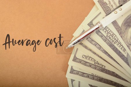 Photo for Money banknotes and pen with text AVERAGE COST. average cost of a product or service - Royalty Free Image