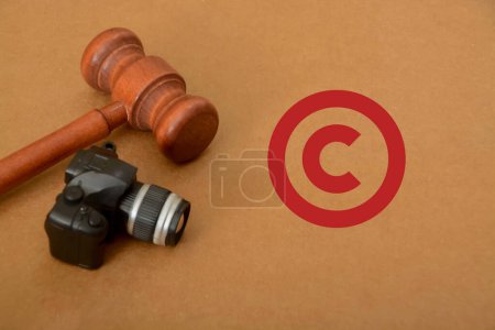 Photo for Copyright symbol with judge gavel and camera. Image copyright is a specific aspect of copyright law that pertains to the protection of original images and photographs - Royalty Free Image
