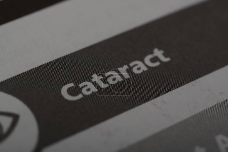 Photo for Close up view of the word CATARACT. A cataract is a common eye condition characterized by the clouding of the eye's natural lens, which is typically clear - Royalty Free Image
