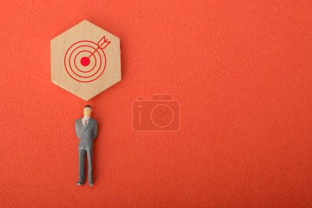 Photo for Employing a creative approach, such as utilizing a hand-held target board, aids in setting precise business objectives and emphasizes the attainment of set goals. - Royalty Free Image