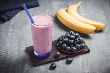 Blueberry and banana smoothie drink in a glass, healthy eating concept.