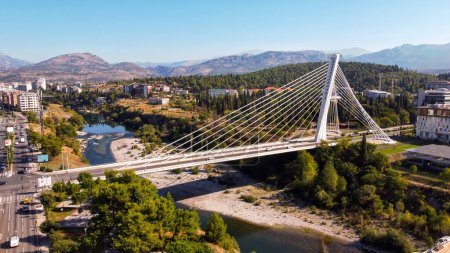 Photo for Aerial drone view of Podgorica, Montenegro. River with a bridge over it, a lot of greenery, buildings - Royalty Free Image