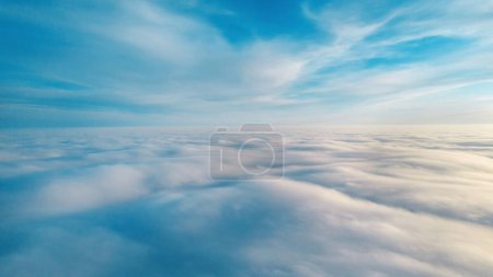 Aerial view from a drone flying above the lush clouds