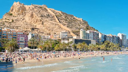 Photo for ALICANTE, SPAIN - APRIL 2023: People on a beach near mountain Benacantil and Santa Barbara Castle - Royalty Free Image