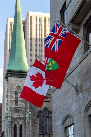 Ottawa, Canada - May 16, 2024: Canadian and Ontario flags on the wall of Lord Elgin hotel building in downtown