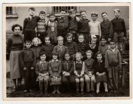 Photo for THE CZECHOSLOVAK SOCIALIST REPUBLIC - CIRCA 1960: A vintage photo shows schoolmates with female teacher. - Royalty Free Image