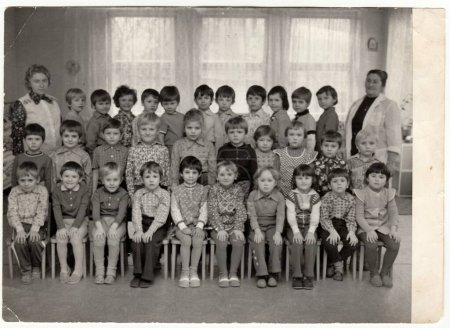 THE CZECHOSLOVAK SOCIALIST REPUBLIC - CIRCA 1976: Retro photo shows children in kindergarten with their female teachers.