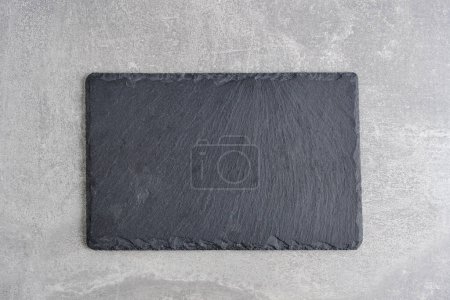 Photo for Slate cutting board on a light concrete background - Royalty Free Image