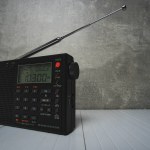 Digital radio receiver with elongated antenna gray concrete background