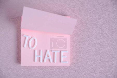 Photo for Word hate laid out white letters pink piece paper.Concept hatred, anger and denial - Royalty Free Image
