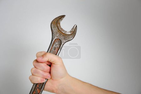 Photo for Wrench in hand gray background, concept Labor Day first May - Royalty Free Image
