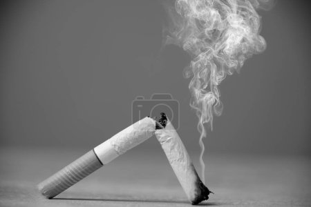 Broken smoking cigarette in black and white photo
