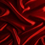 Abstract background made of red silk wavy fabric