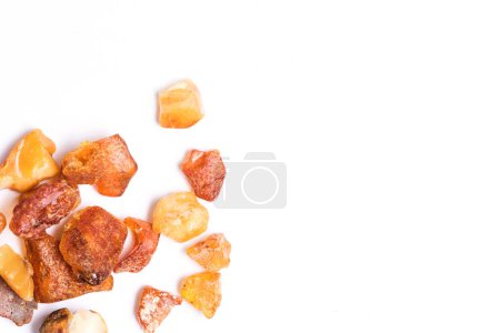 Bright raw Baltic amber on white background