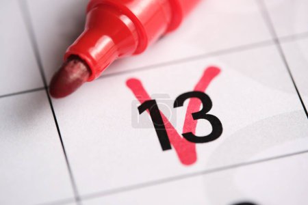 13th day on the calendar is marked with a red marker.Friday the thirteenth.