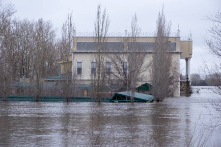 Flooded houses on the riverbank during the spring flood