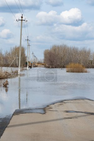 Spring flood on the river. Flood of river. Flooding of road with water
