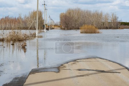 Flooded road in the countryside in springtime. Natural disaster