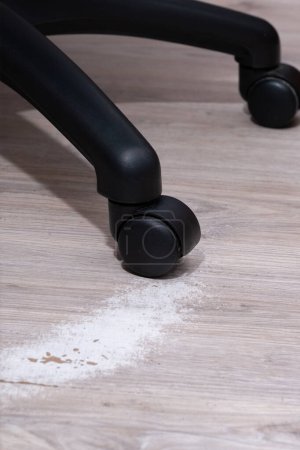 Closeup video of an office chair with a white wipe floor