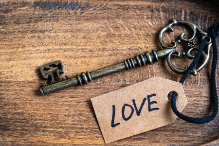 Photo for Vintage key with tag and inscription love on it. Concept love and relationships - Royalty Free Image