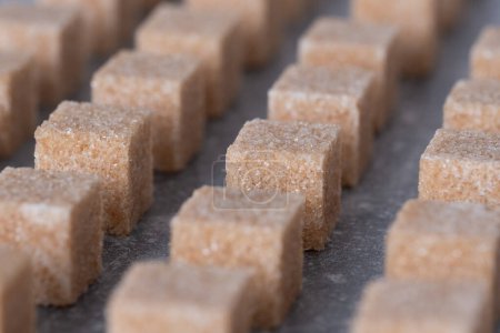 Straight rows of cane sugar cubes. Effect of dynamics.