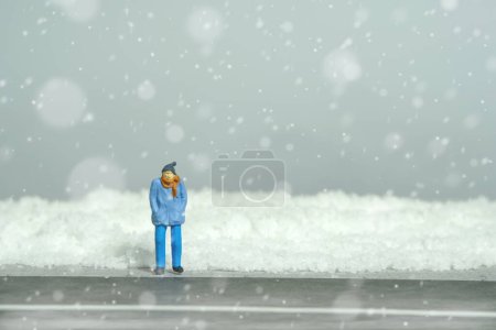 Photo for Miniature people toy figure photography. Transportation problem during winter. A man waiting on empty road during snowstorm. Image photo - Royalty Free Image