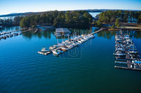 Aerial shot of the boats and yachts docked in the marina on the waters of Lake Lanier surrounded by lush green trees in Buford Georgia USA
