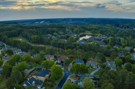 An aerial  panoramic view of an upscale sub division in suburbs of USA shot during sunset in spring of 2024